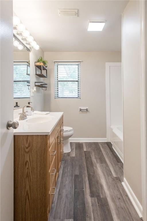 1348 Crestridge Rd, Waycross, GA 31503 - full bathroom featuring vanity, wood finished floors, and a tub