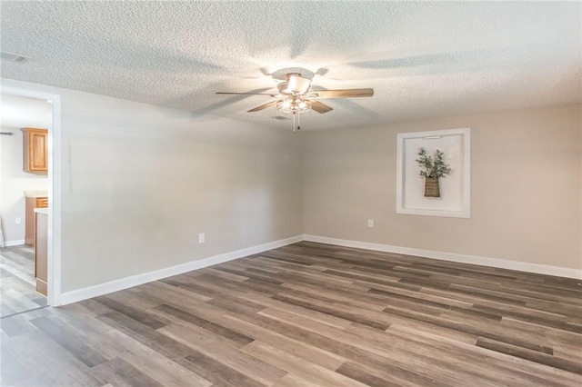 1348 Crestridge Rd, Waycross, GA 31503 - spare room with a textured ceiling, ceiling fan, and wood finished floors