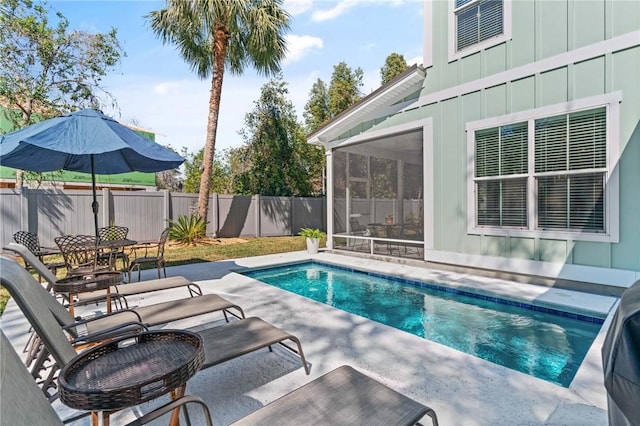 view of swimming pool with a fenced in pool, a patio, a sunroom, fence, and outdoor dining space