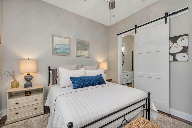 121 Calwell St, Saint Simons Island, GA 31522 - bedroom featuring a barn door and connected bathroom