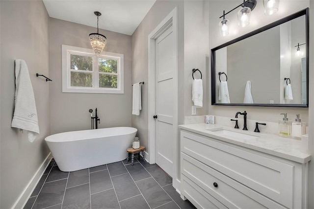 121 Calwell St, Saint Simons Island, GA 31522 - bathroom featuring a freestanding tub, vanity, and a chandelier