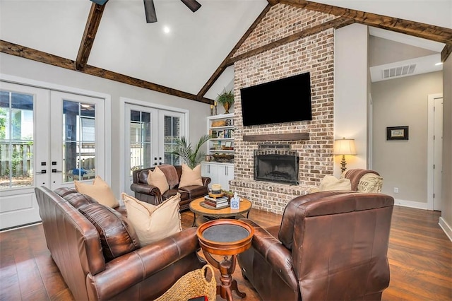 121 Calwell St, Saint Simons Island, GA 31522 - living room with french doors, dark wood finished floors, ceiling fan, beamed ceiling, and a fireplace