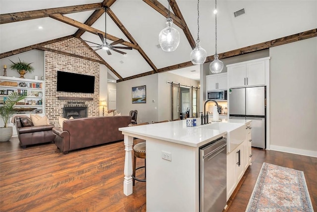 121 Calwell St, Saint Simons Island, GA 31522 - kitchen featuring appliances with stainless steel finishes, open floor plan, and white cabinets