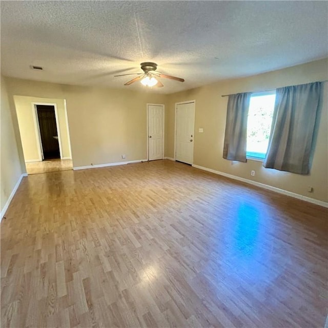 1110 Waller St, Waycross, GA 31501 - spare room with baseboards, wood finished floors, a textured ceiling, and ceiling fan