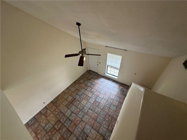 additional living space featuring a ceiling fan and a textured ceiling