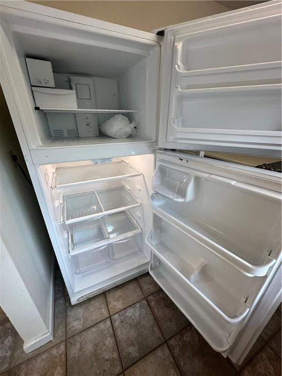 details featuring light countertops, white cabinetry, and refrigerator