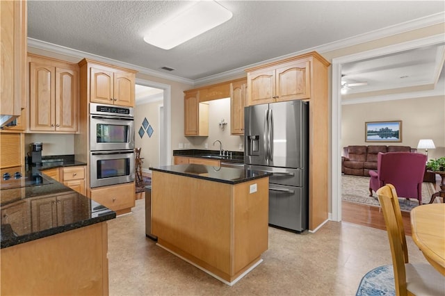 kitchen featuring sink, light brown cabinets, ornamental molding, and stainless steel appliances