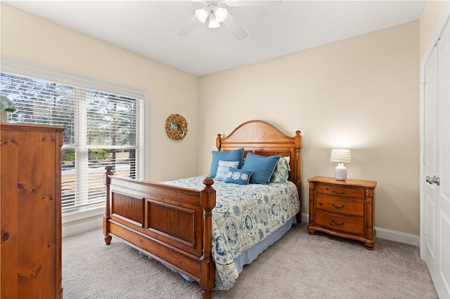 bedroom with ceiling fan and light colored carpet