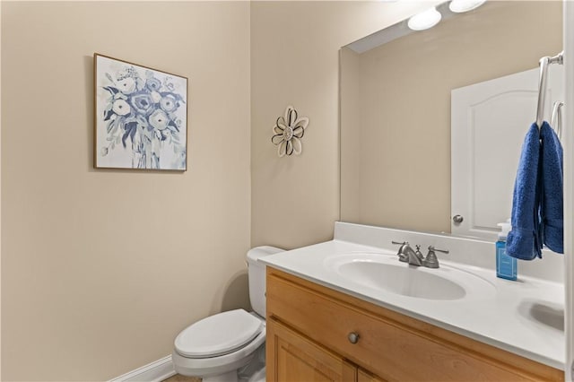 bathroom featuring toilet and vanity