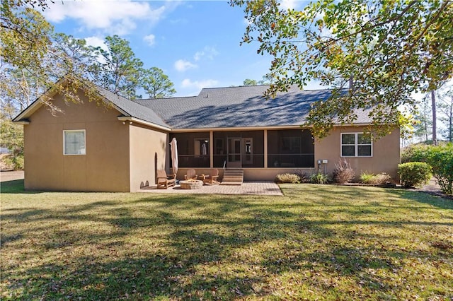 back of property with an outdoor fire pit, a patio area, a yard, and a sunroom