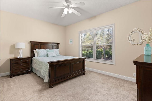 bedroom with ceiling fan and light colored carpet