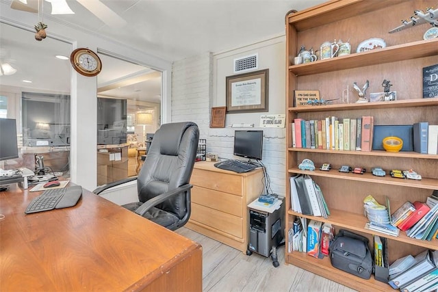 office with ceiling fan, wood finished floors, and visible vents
