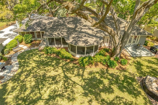 rear view of house with a patio area, french doors, a sunroom, and a yard