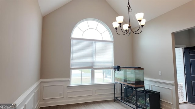 interior space featuring a decorative wall, a wainscoted wall, and a healthy amount of sunlight