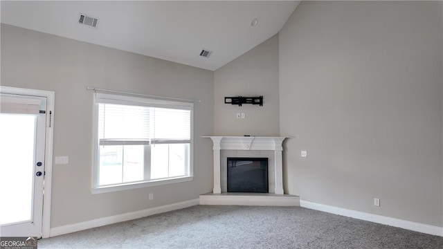unfurnished living room featuring carpet flooring, baseboards, vaulted ceiling, and visible vents