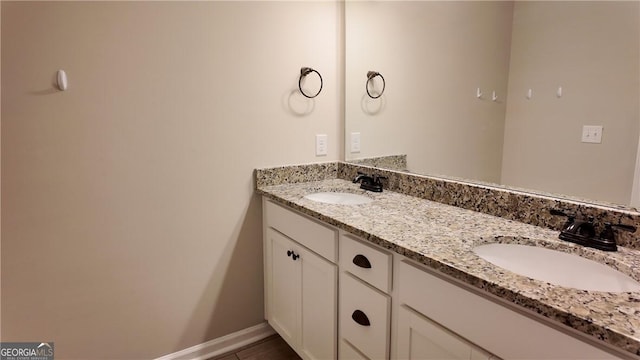 bathroom featuring double vanity and a sink
