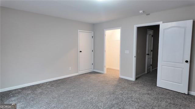 unfurnished bedroom featuring carpet flooring and baseboards