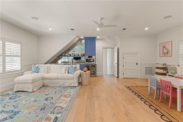 329 Saint Annies Ln, Saint Simons Island, GA 31522 - living area with ornamental molding, beverage cooler, light wood finished floors, ceiling fan, and a decorative wall