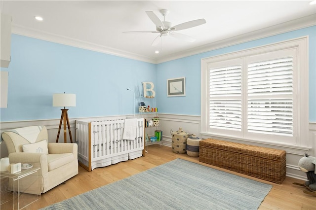 329 Saint Annies Ln, Saint Simons Island, GA 31522 - bedroom featuring crown molding, wainscoting, wood finished floors, recessed lighting, and a ceiling fan
