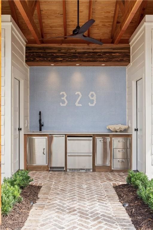 329 Saint Annies Ln, Saint Simons Island, GA 31522 - miscellaneous room with ceiling fan, a wood ceiling with exposed beams, and brick flooring