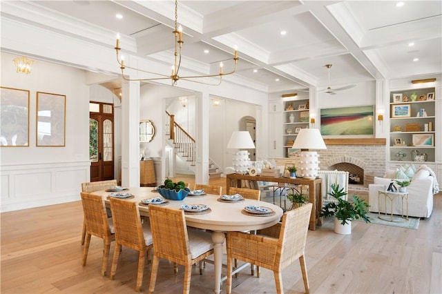 329 Saint Annies Ln, Saint Simons Island, GA 31522 - dining area with stairway, light wood-type flooring, beamed ceiling, a brick fireplace, and ceiling fan