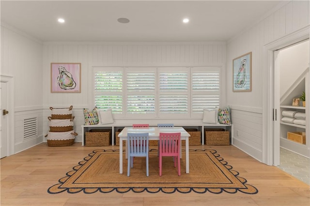 329 Saint Annies Ln, Saint Simons Island, GA 31522 - dining room featuring wood finished floors, a decorative wall, crown molding, and recessed lighting