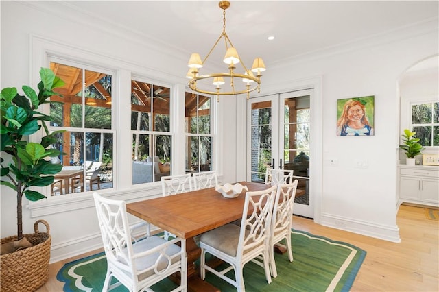 329 Saint Annies Ln, Saint Simons Island, GA 31522 - sunroom / solarium with a chandelier, arched walkways, and french doors