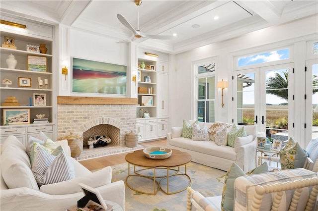 329 Saint Annies Ln, Saint Simons Island, GA 31522 - living room with light wood-type flooring, built in features, beam ceiling, ceiling fan, and ornamental molding