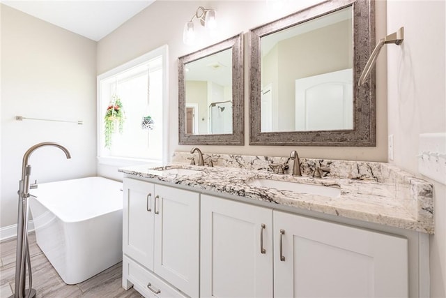 119 Silver Bluff Dr, Brunswick, GA 31523 - bathroom with double vanity, a freestanding bath, wood finished floors, and a shower