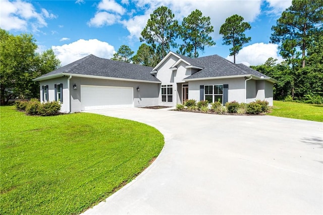 119 Silver Bluff Dr, Brunswick, GA 31523 - view of front of property featuring stucco siding, driveway, a front lawn, and an attached garage