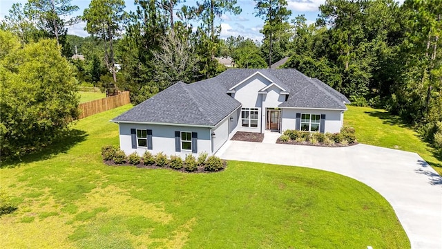 119 Silver Bluff Dr, Brunswick, GA 31523 - view of front of property featuring concrete driveway, stucco siding, a garage, and roof with shingles