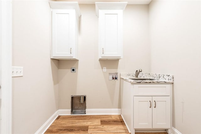 119 Silver Bluff Dr, Brunswick, GA 31523 - laundry area with electric dryer hookup, light wood-style flooring, hookup for a washing machine, and cabinet space
