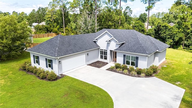 119 Silver Bluff Dr, Brunswick, GA 31523 - ranch-style home featuring an attached garage, stucco siding, a shingled roof, driveway, and view of scattered trees