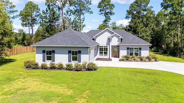 119 Silver Bluff Dr, Brunswick, GA 31523 - view of front of property with stucco siding, driveway, an attached garage, and roof with shingles