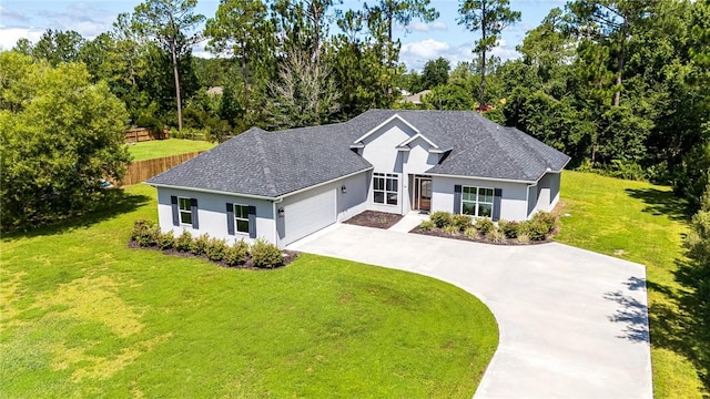119 Silver Bluff Dr, Brunswick, GA 31523 - view of front facade with stucco siding, concrete driveway, an attached garage, and roof with shingles