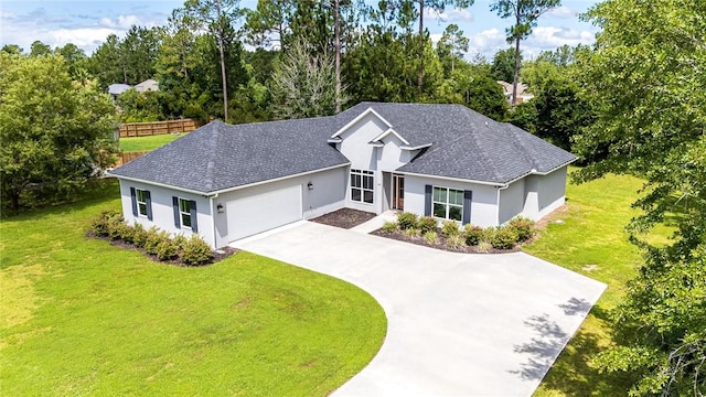 119 Silver Bluff Dr, Brunswick, GA 31523 - single story home with stucco siding, an attached garage, driveway, roof with shingles, and view of wooded area