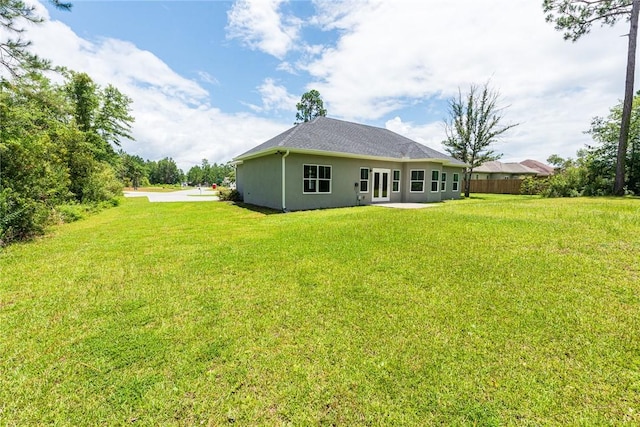 119 Silver Bluff Dr, Brunswick, GA 31523 - rear view of house featuring a yard and stucco siding