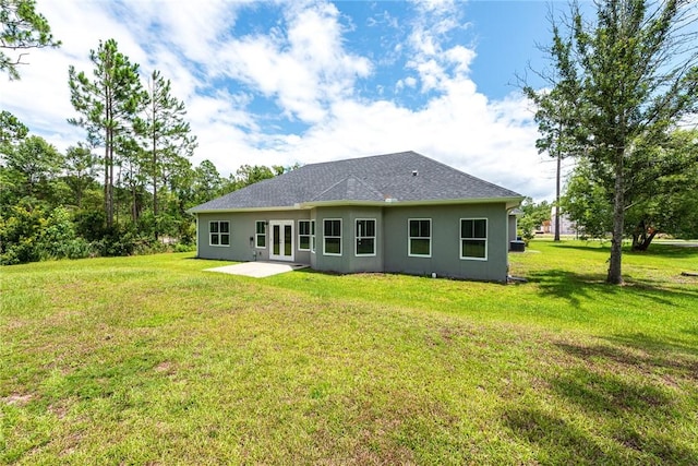 119 Silver Bluff Dr, Brunswick, GA 31523 - rear view of property with stucco siding, a lawn, and a patio area