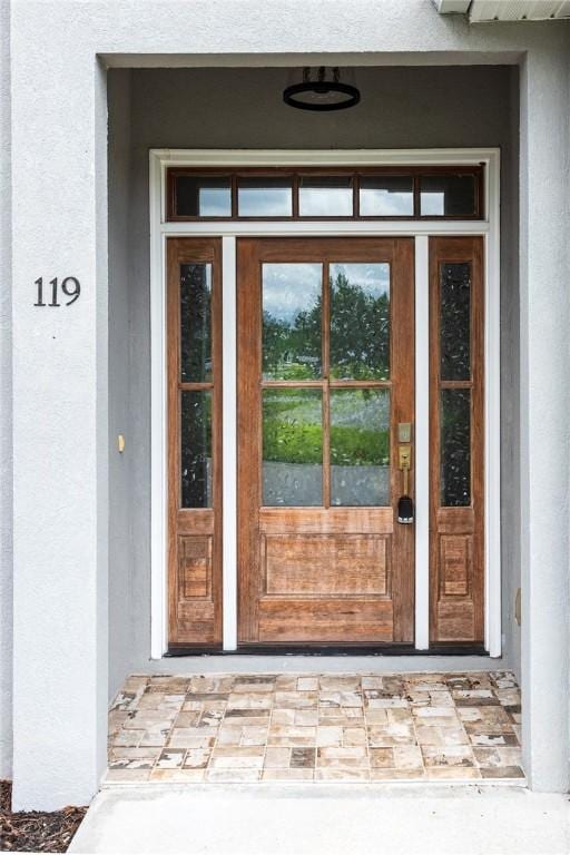 119 Silver Bluff Dr, Brunswick, GA 31523 - view of exterior entry featuring stucco siding