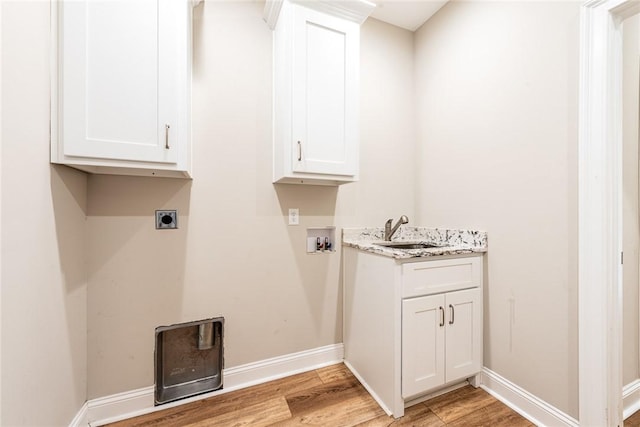 119 Silver Bluff Dr, Brunswick, GA 31523 - laundry room featuring light wood finished floors, electric dryer hookup, hookup for a washing machine, and cabinet space