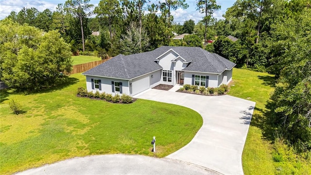 119 Silver Bluff Dr, Brunswick, GA 31523 - ranch-style home with concrete driveway, a garage, stucco siding, and a front yard