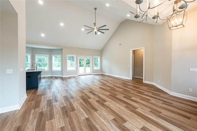 119 Silver Bluff Dr, Brunswick, GA 31523 - unfurnished living room with high vaulted ceiling, wood finished floors, ceiling fan, a chandelier, and recessed lighting