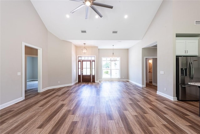 119 Silver Bluff Dr, Brunswick, GA 31523 - unfurnished living room with high vaulted ceiling, a chandelier, a ceiling fan, and wood finished floors