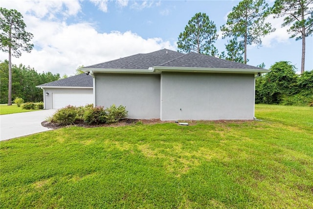 119 Silver Bluff Dr, Brunswick, GA 31523 - view of side of home featuring concrete driveway, a lawn, an attached garage, and a shingled roof