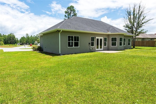 119 Silver Bluff Dr, Brunswick, GA 31523 - rear view of house featuring french doors, stucco siding, and a shingled roof