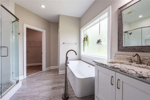 119 Silver Bluff Dr, Brunswick, GA 31523 - full bath with a shower stall, vanity, a walk in closet, a freestanding bath, and recessed lighting