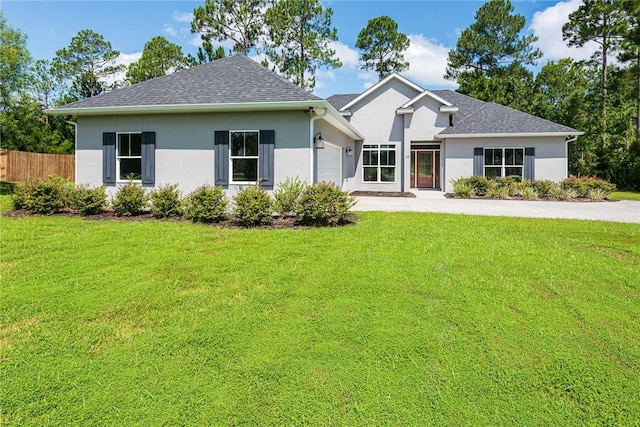 119 Silver Bluff Dr, Brunswick, GA 31523 - view of front of property featuring an attached garage, stucco siding, concrete driveway, and roof with shingles