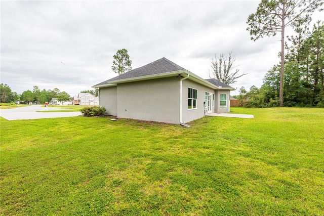 119 Silver Bluff Dr, Brunswick, GA 31523 - view of home's exterior featuring a lawn and stucco siding