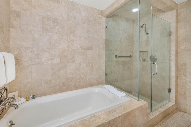 10 Dune Ave Unit 18Int 3, Sea Island, GA 31561 - bathroom featuring tile patterned flooring, shower with separate bathtub, and tile walls