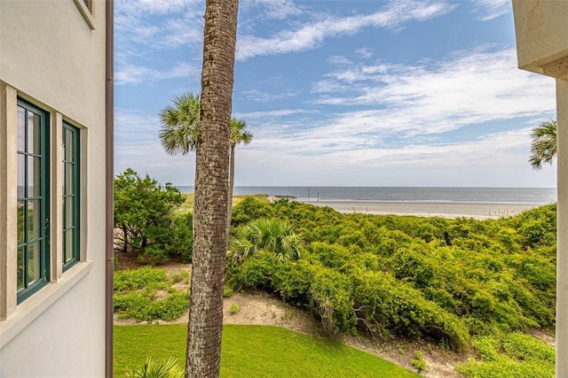 view of yard with a view of the beach and a water view